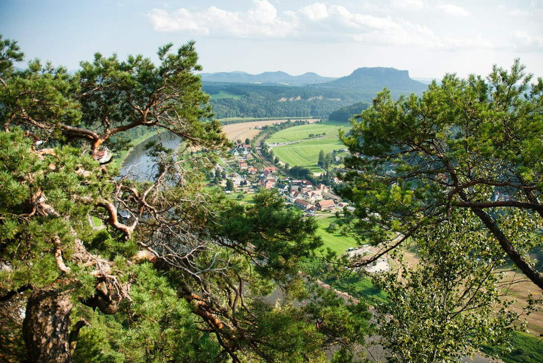 Scenic German countryside with green hills and mountains under a clear sky