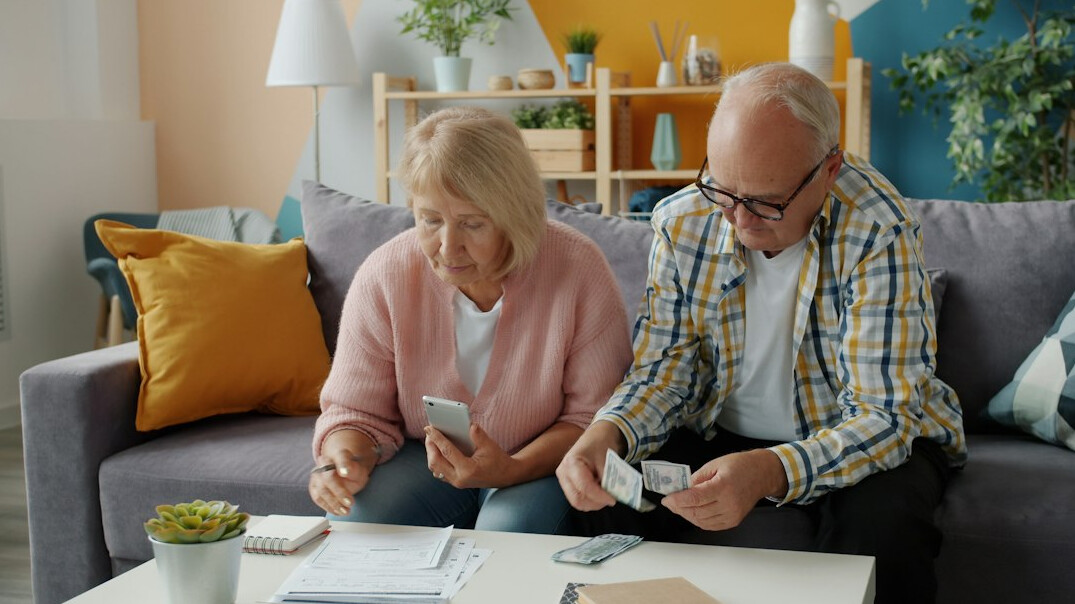 elderly couple discussing finances