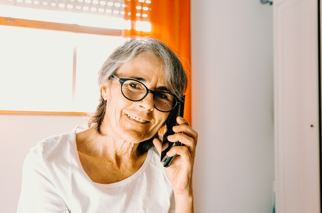 senior woman using calculator